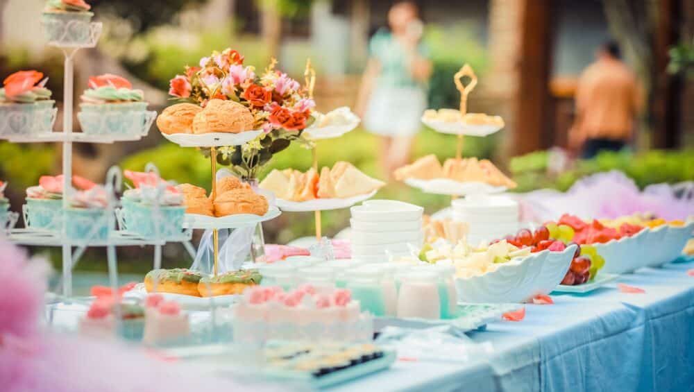 various desserts on a table covered with baby blue cover